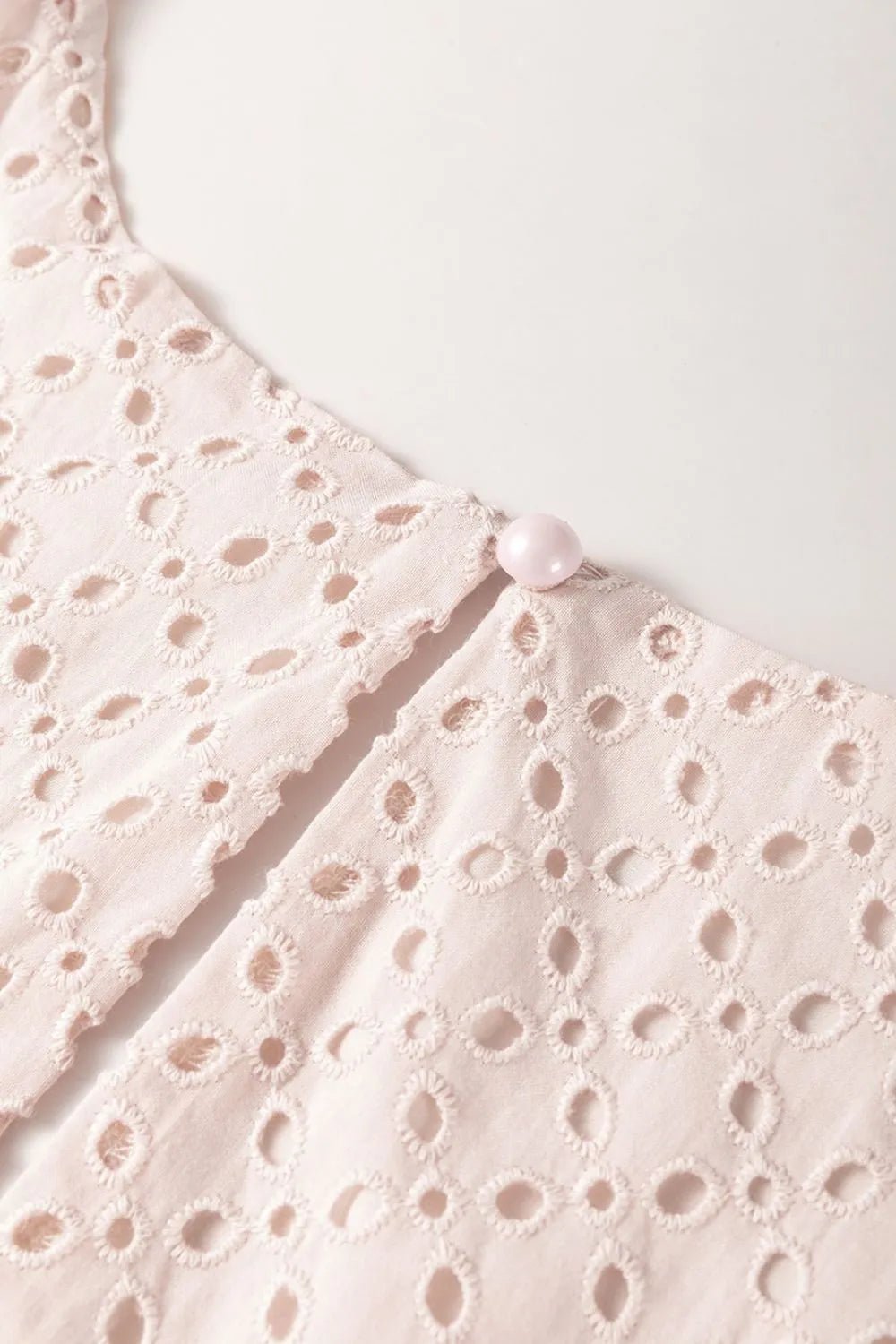 Embroidered Eyelets Ruffled Hem Sleeveless Mini Dress designed for comfort and style at Lookzlike