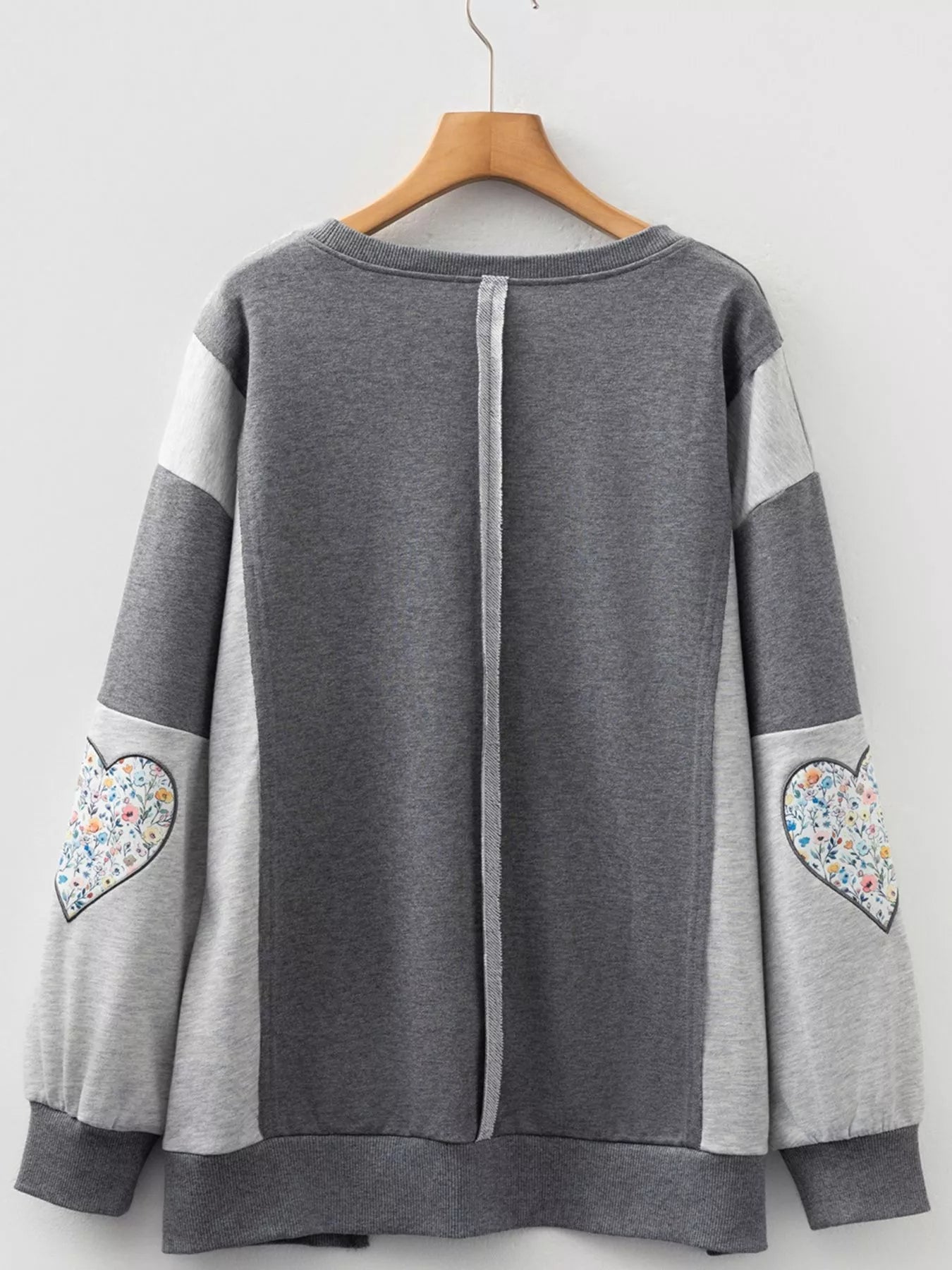 LOVE Graphic Exposed Seam Patchwork Uneven Hem Chic Sweatshirt designed for comfort and style at Lookzlike