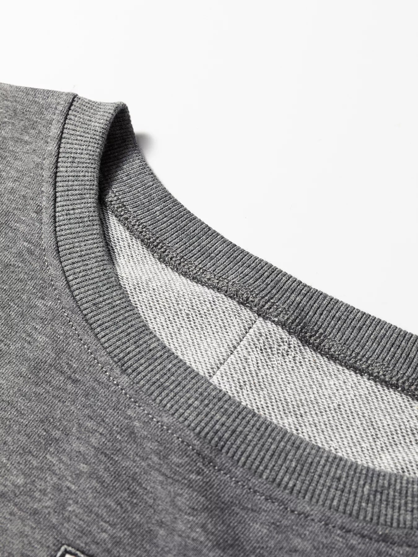 LOVE Graphic Exposed Seam Patchwork Uneven Hem Chic Sweatshirt designed for comfort and style at Lookzlike