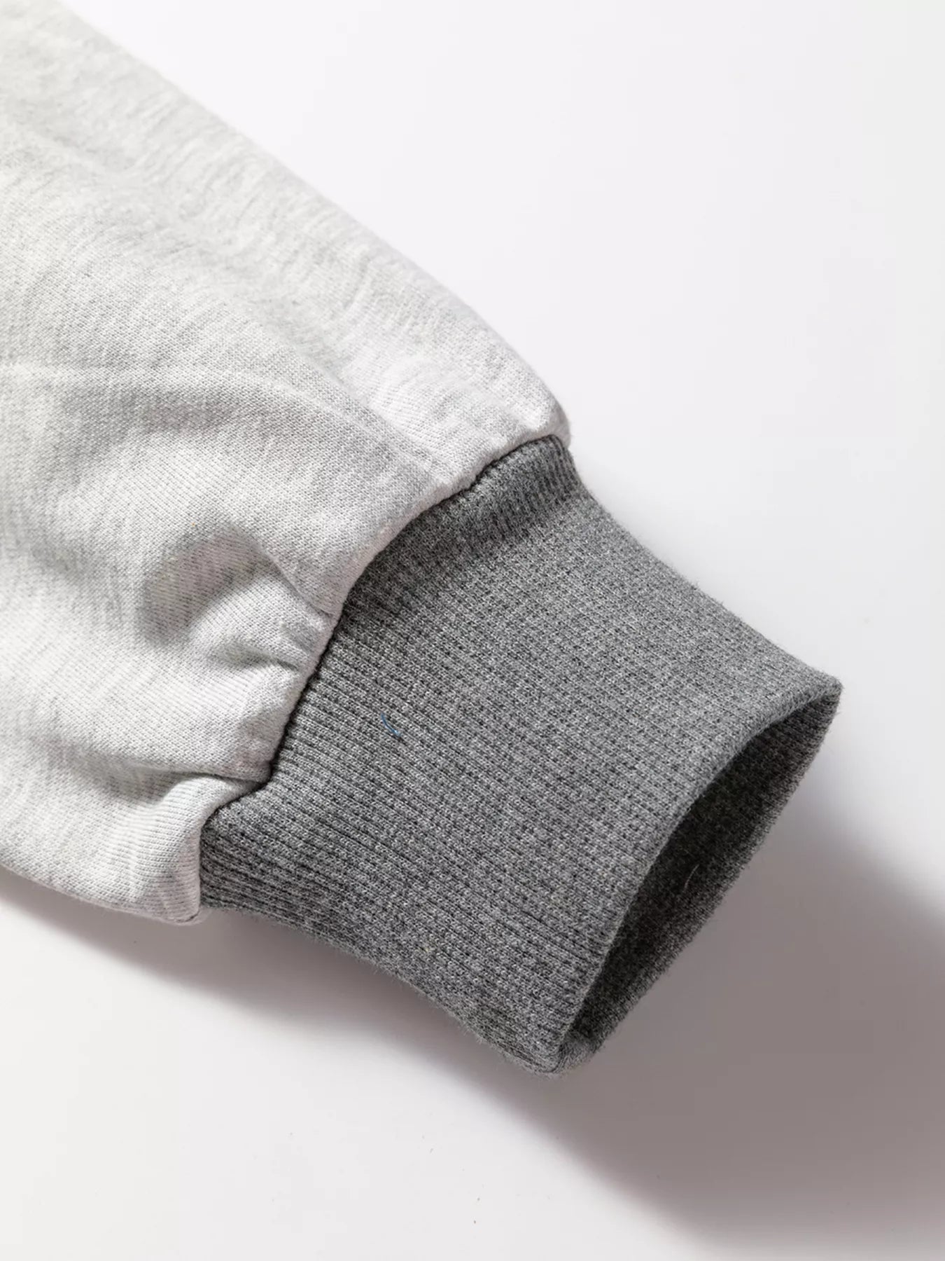 LOVE Graphic Exposed Seam Patchwork Uneven Hem Chic Sweatshirt designed for comfort and style at Lookzlike