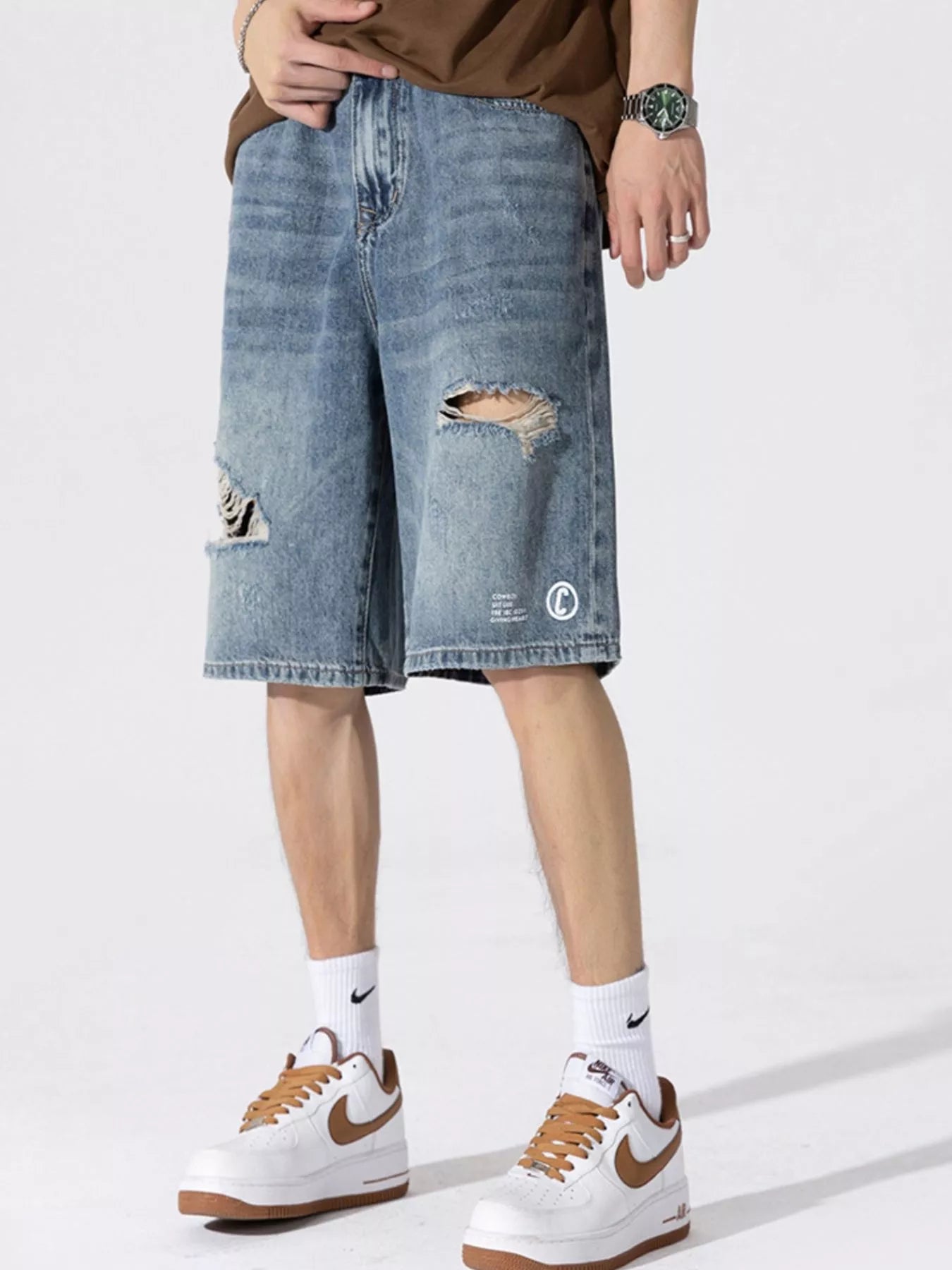 Men's Distressed Loose Fit Denim Shorts designed for comfort and style at Lookzlike