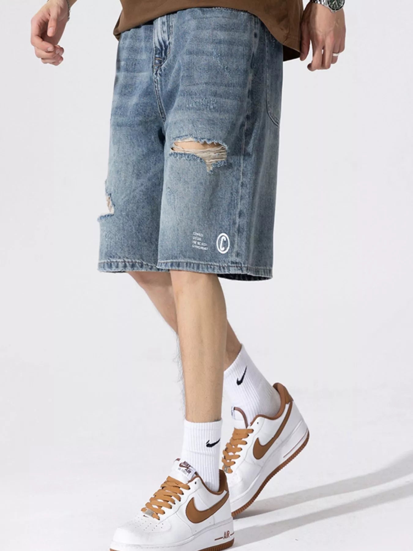 Men's Distressed Loose Fit Denim Shorts designed for comfort and style at Lookzlike