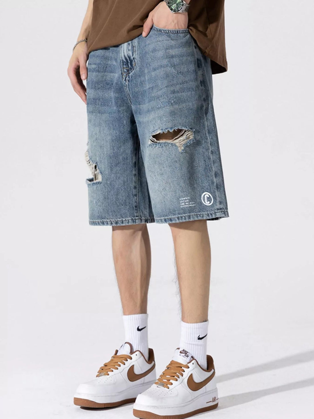 Men's Distressed Loose Fit Denim Shorts designed for comfort and style at Lookzlike